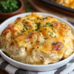 Chicken Bubble Biscuit Bake in casserole dish with golden biscuits and cheese